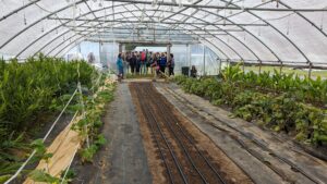 Grower Meredith Leight talks about production in one of her five high tunnels during a farm tour.